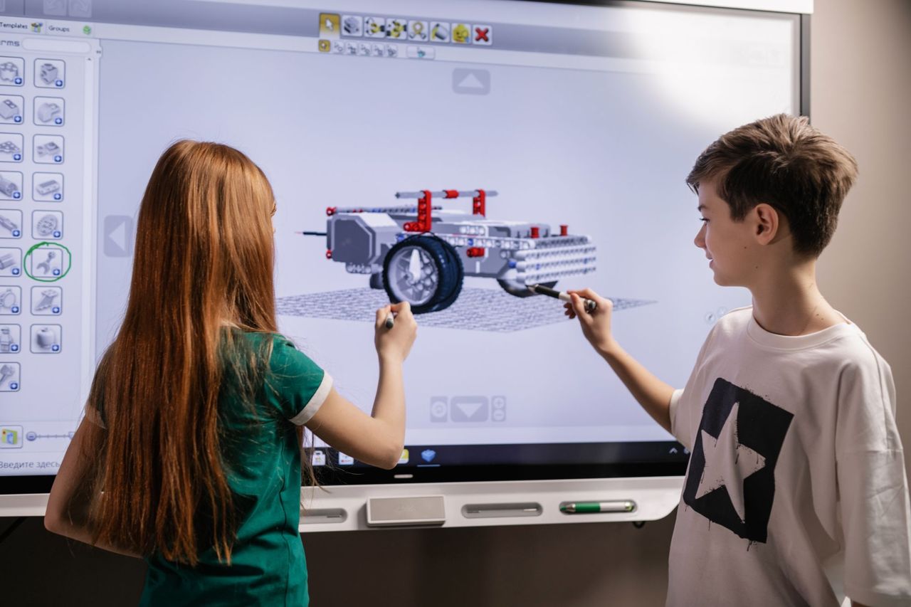 Students using an interactive classroom display