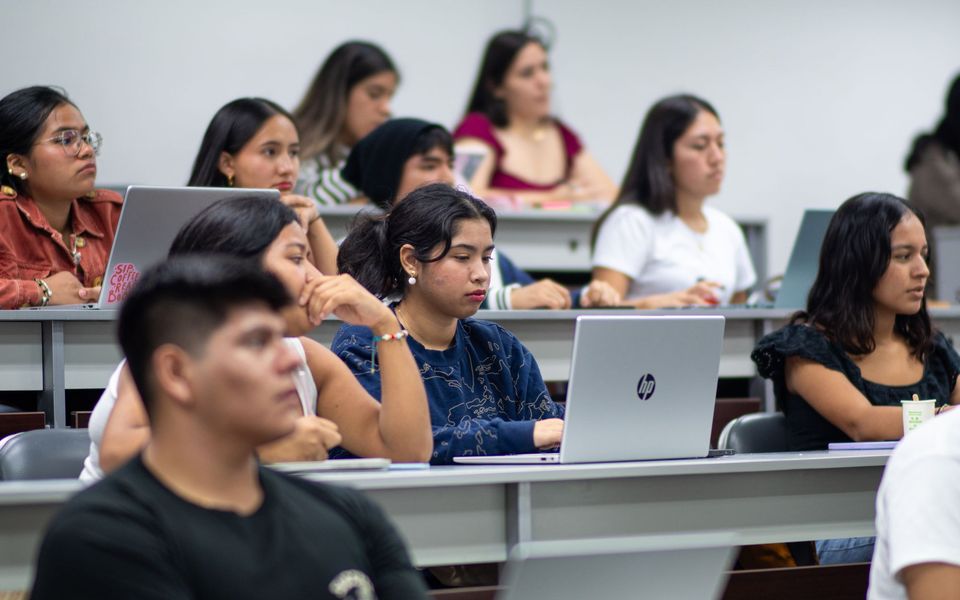 Students working on laptops in a lecture hall