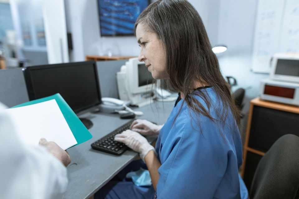 Clinic staff member working at a computer