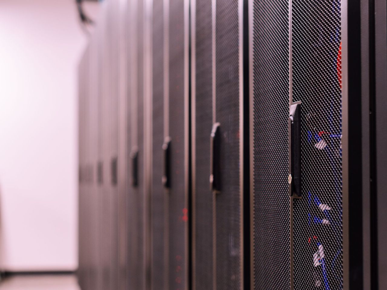 Row of server racks in a softly lit equipment room