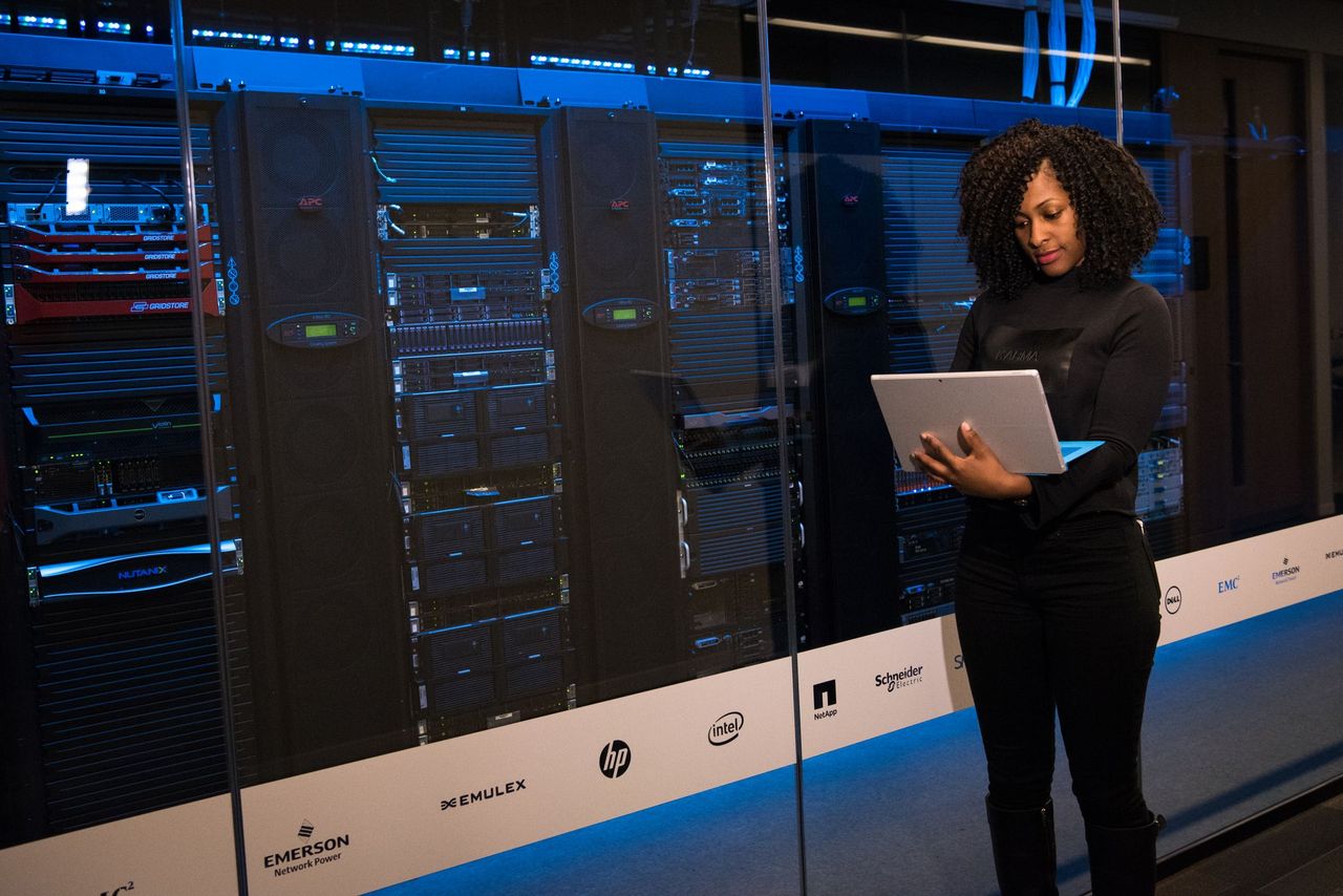Engineer with a laptop in a server room