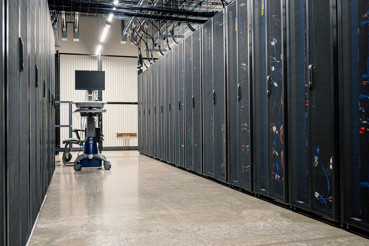 Data center aisle lined with server cabinets