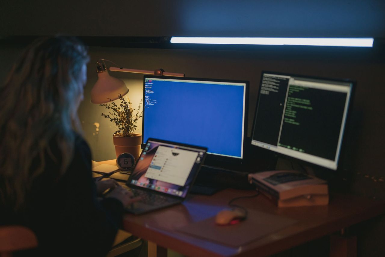 Engineer working at multiple monitors