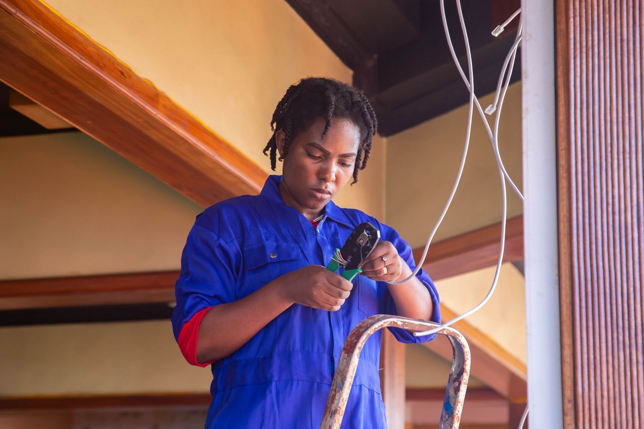 Technician running cable in an office