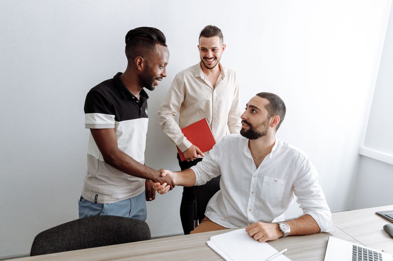 New team member being welcomed with a handshake