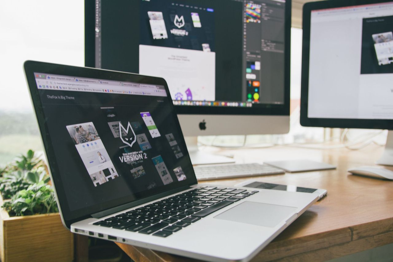 Website design open on a laptop and monitor